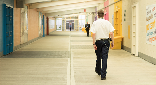 Prison officer walking through prison